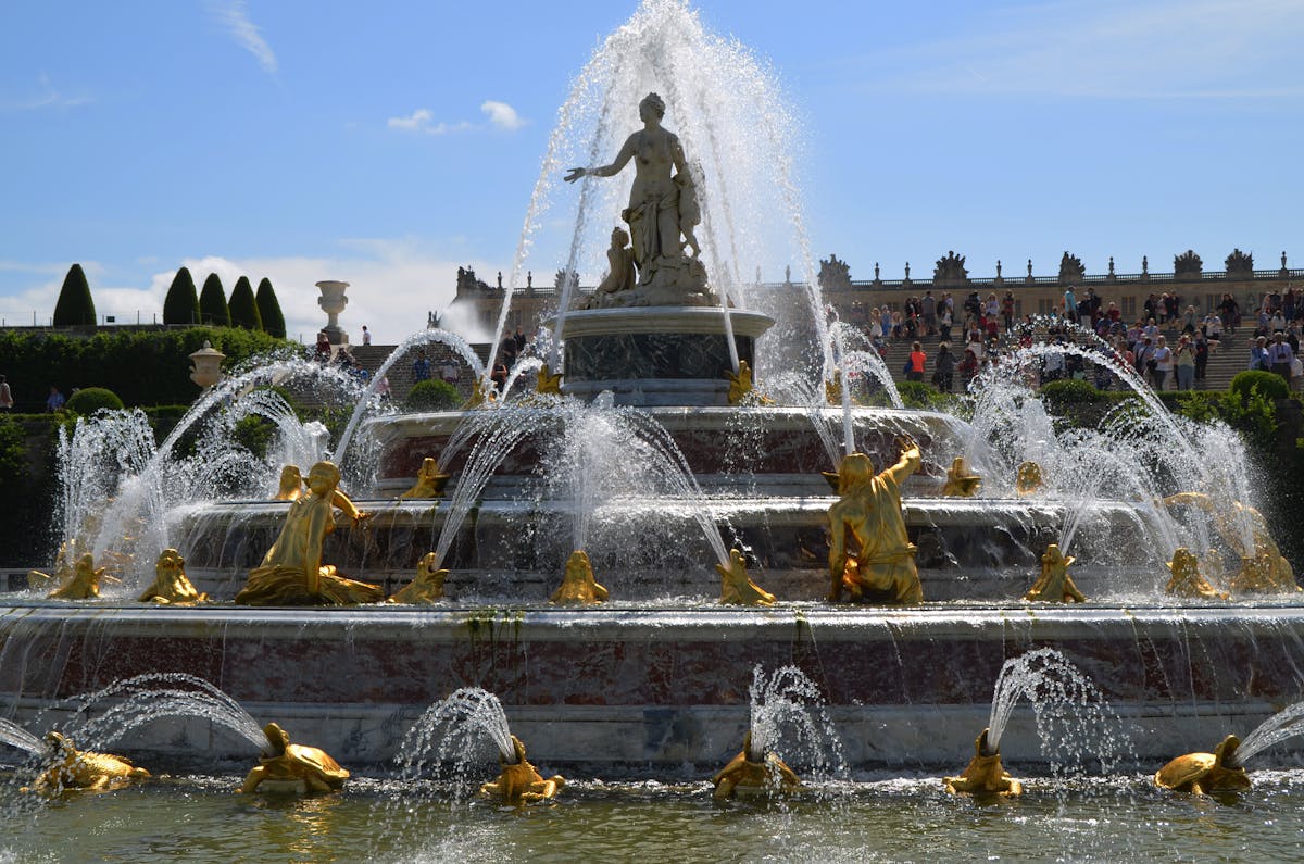 Golden statues of the Fountain of Apollo in the gardens of Versailles