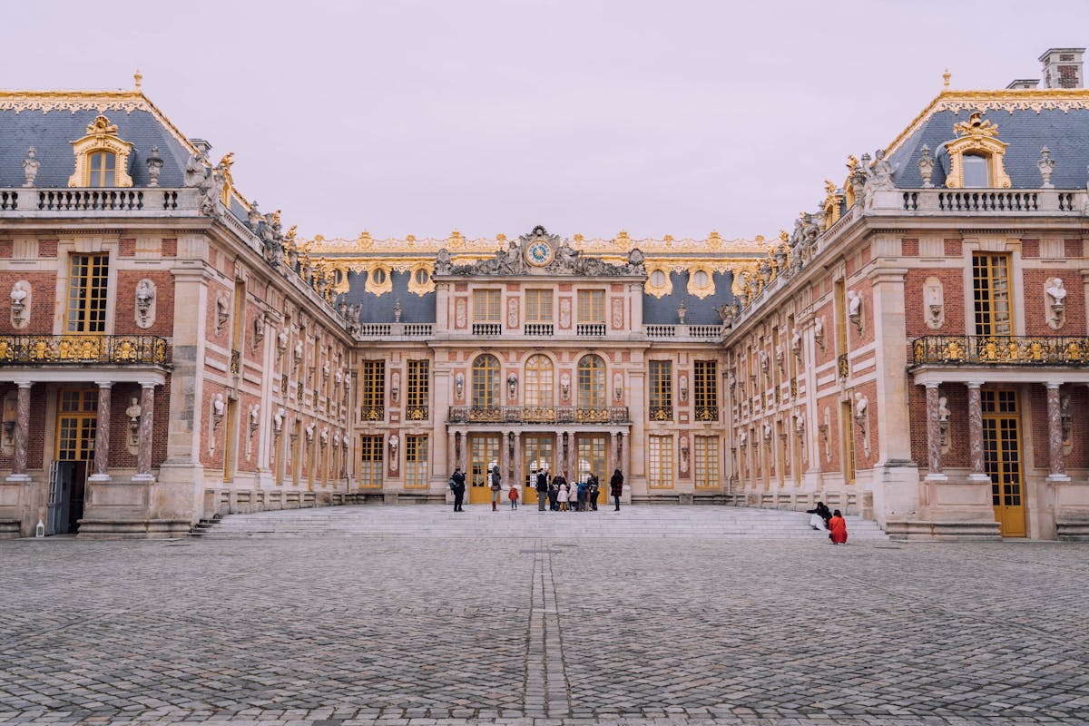 The main courtyard of the Palace of Versailles showing classic French architecture