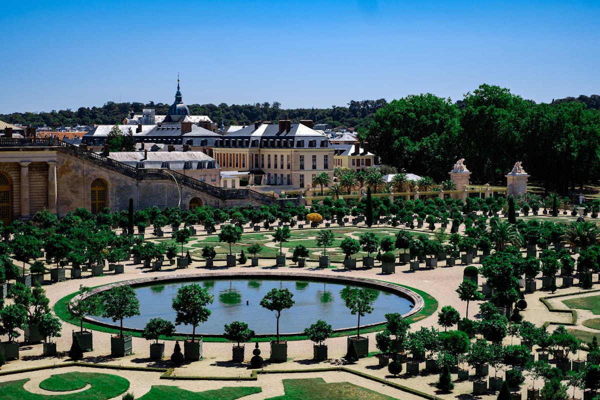 Landscaped gardens at the Palace of Versailles with geometric hedges and fountain