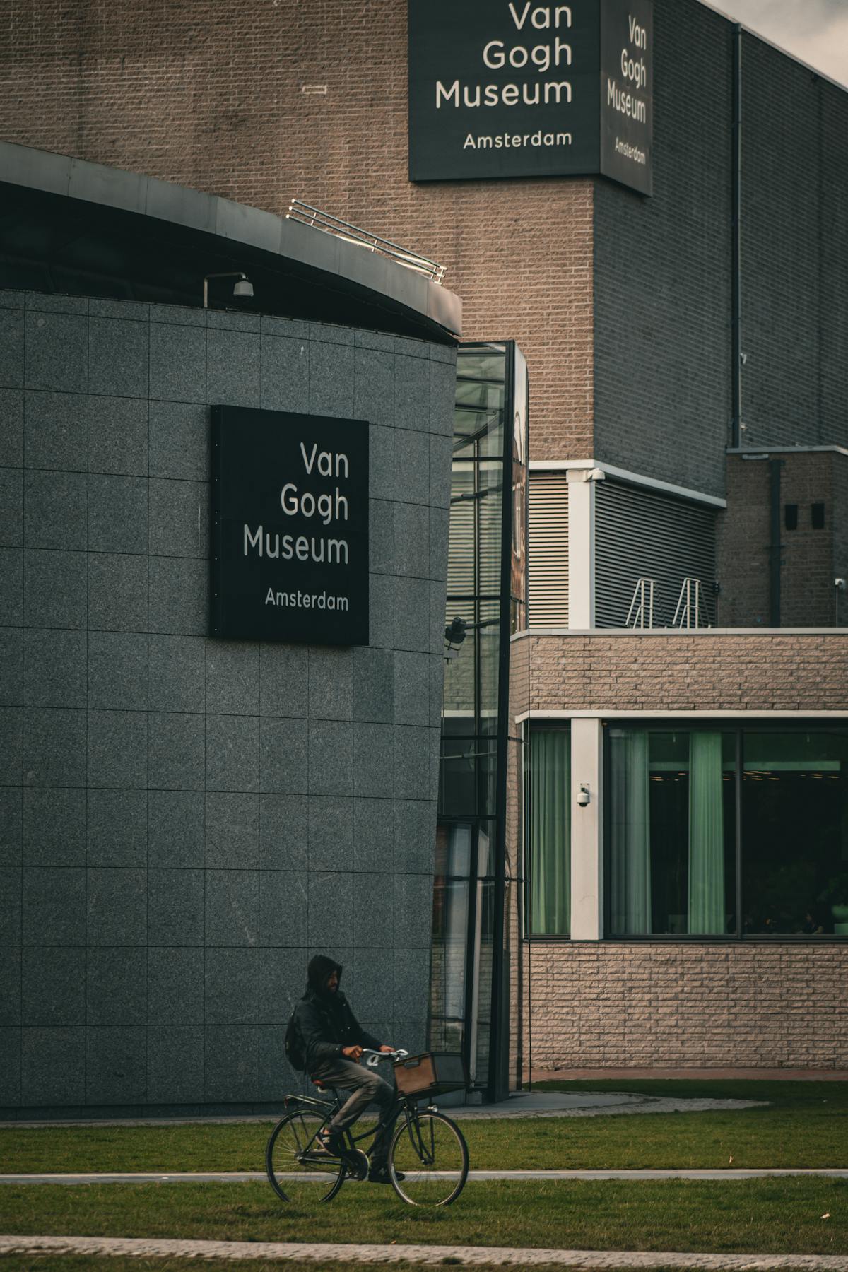 Cyclist passing the Van Gogh Museum in Amsterdam