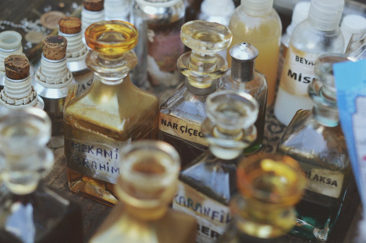 Collection of vintage glass perfume bottles with various labels and shapes