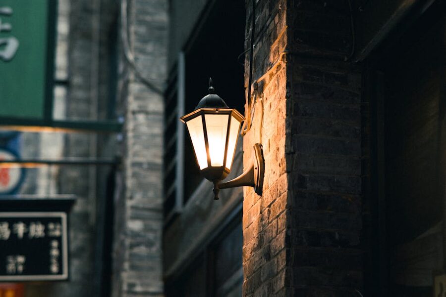 Vintage street lamp illuminating brick alley