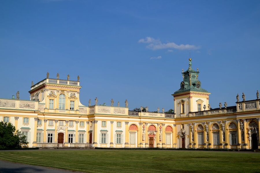 Sunlit baroque facade of Wilanów Palace with formal gardens