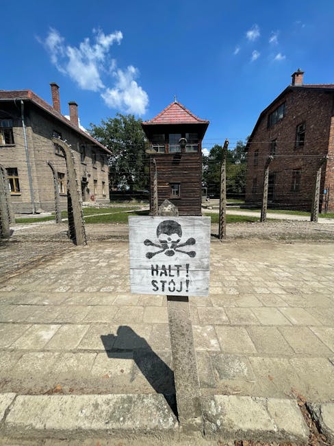 Watchtower and barbed wire at a concentration camp memorial