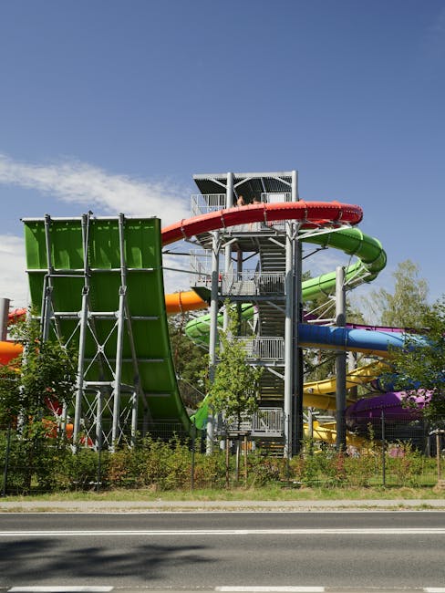 A water park pool area with slides and tropical landscaping