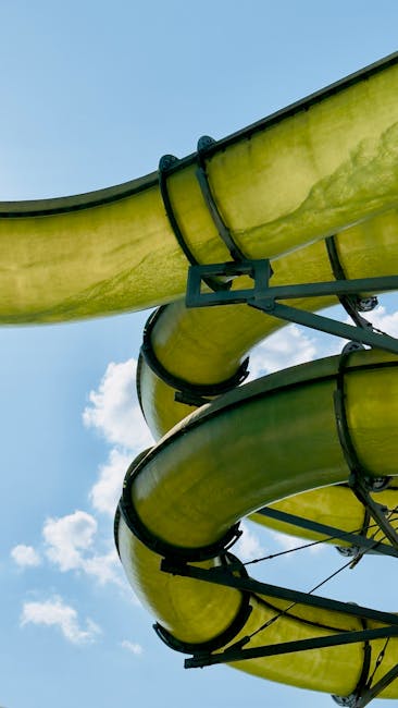 A large enclosed water slide tube curving through a water park