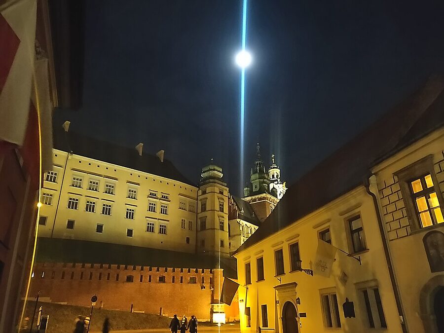 Wawel Castle floodlights illuminating the riverbank at night