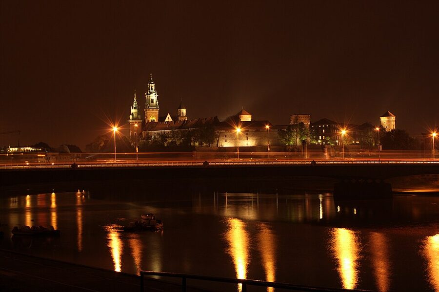 Wawel Castle floodlit from the Vistula River at night