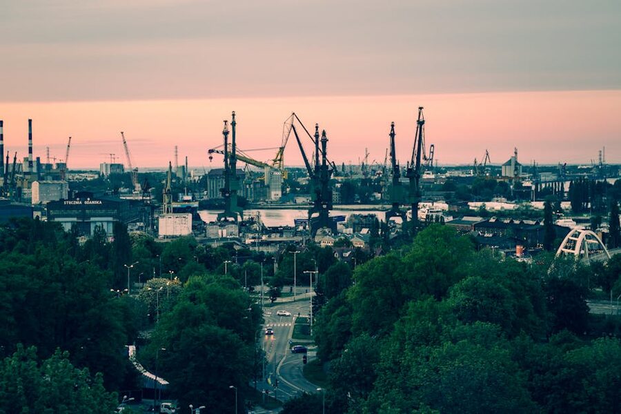 Gdańsk shipyard cranes silhouetted at sunset