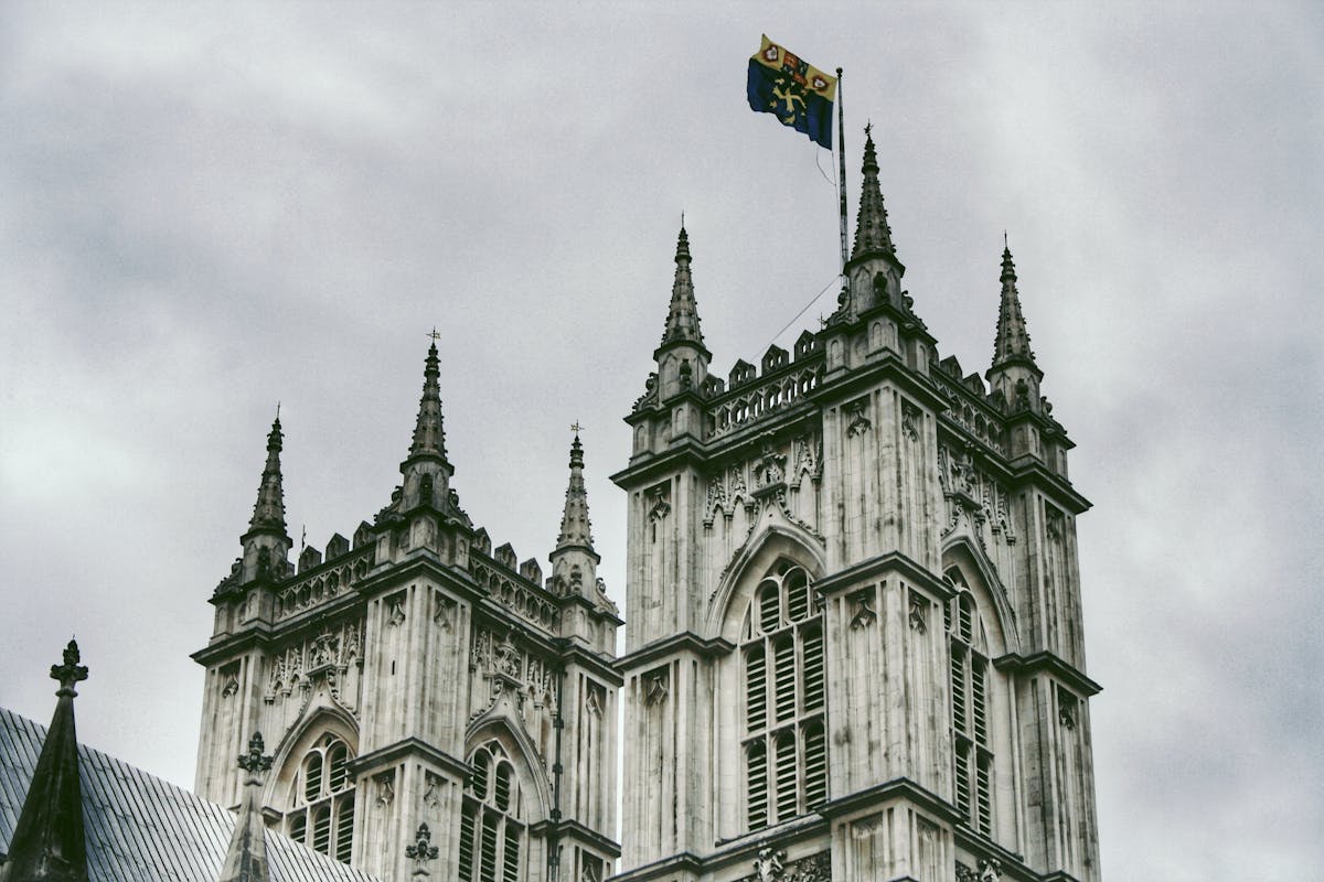 Close-up of Westminster Abbey gothic towers against cloudy sky