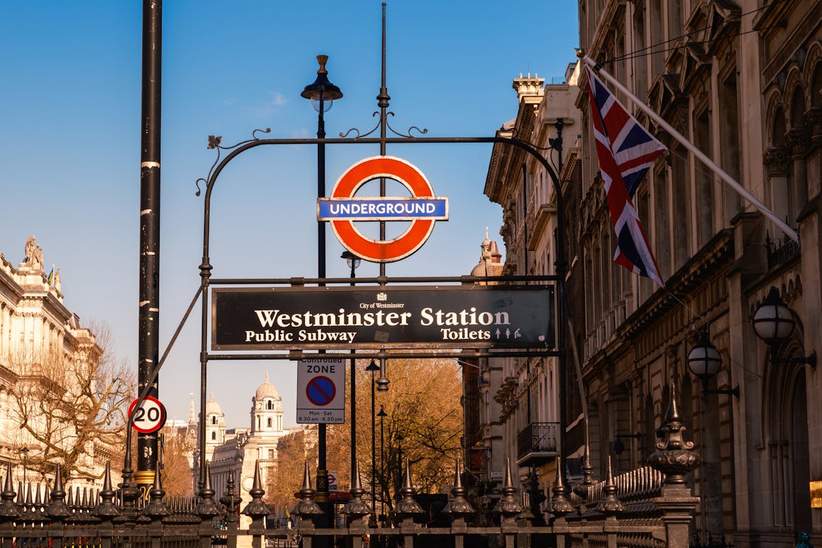 Westminster Station sign in London with architecture and blue sky