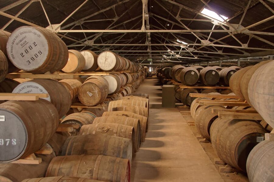 Whiskey barrels aging in distillery warehouse