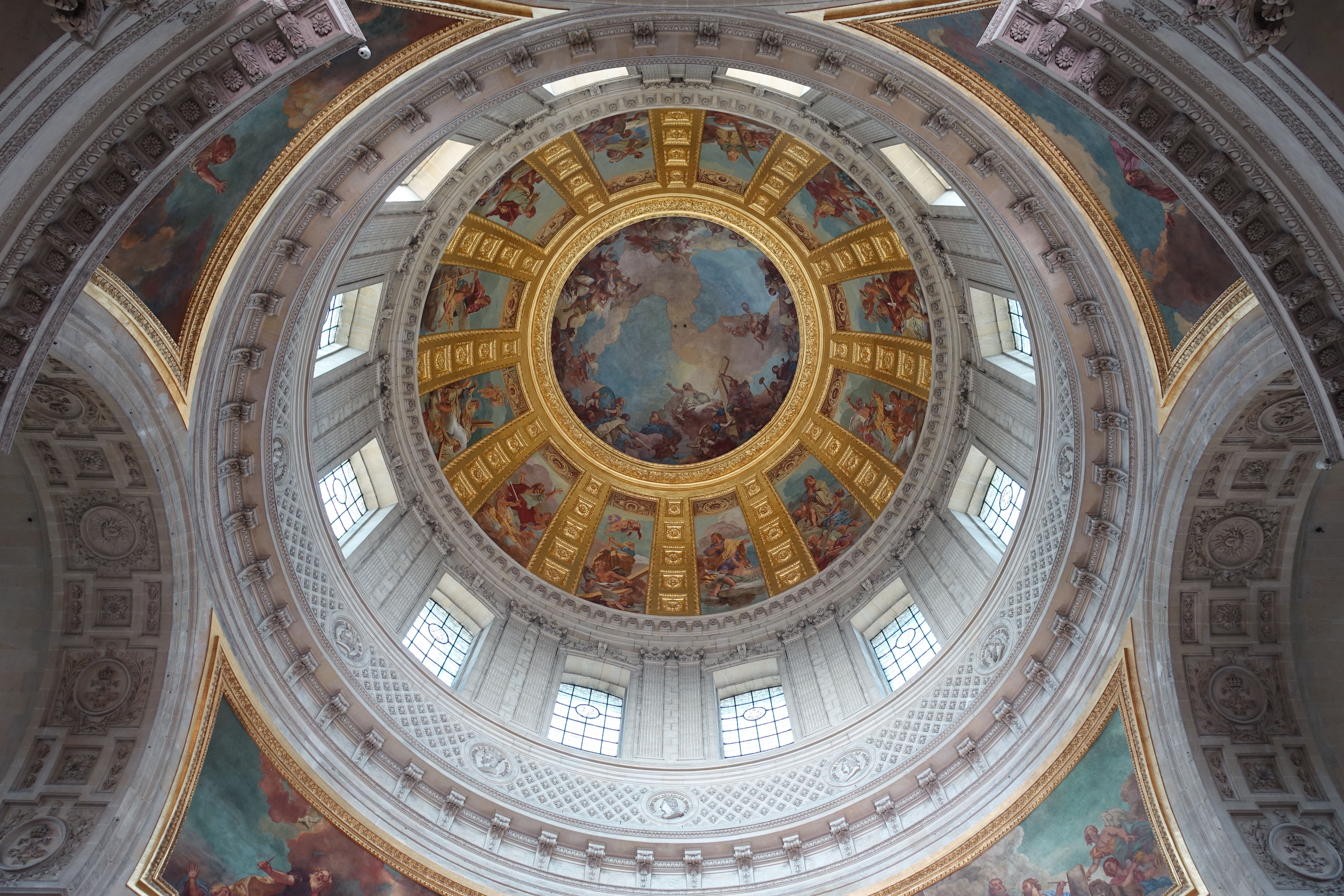 The painted interior dome of Les Invalides church with ornate frescoes and gilded details
