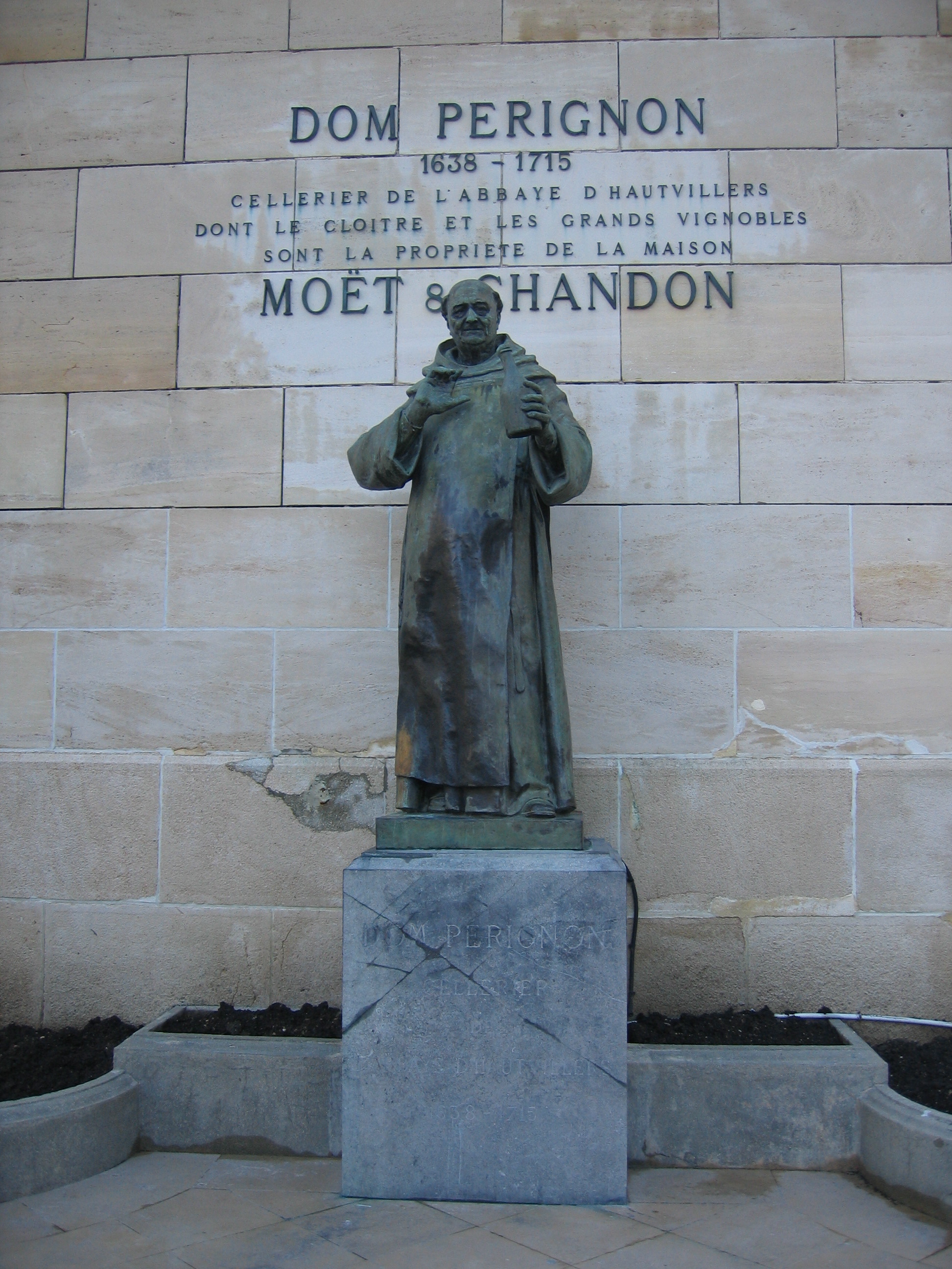Statue of Dom Perignon holding a bottle at Moet and Chandon in Epernay