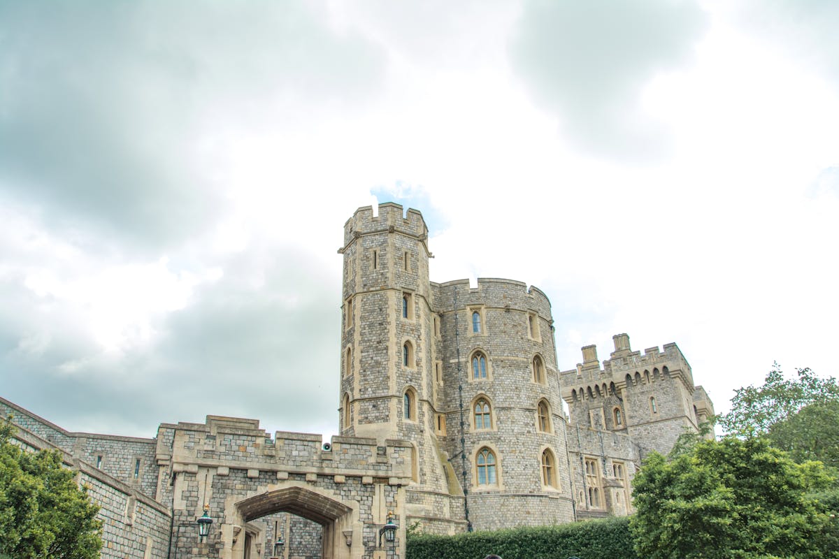 Windsor Castle viewed from below against cloudy sky