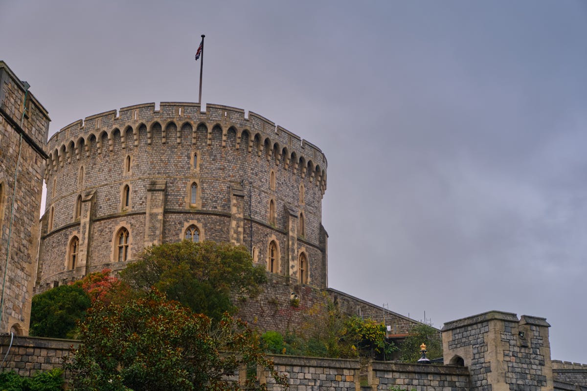 Moody view of Windsor Castle stone tower against grey sky