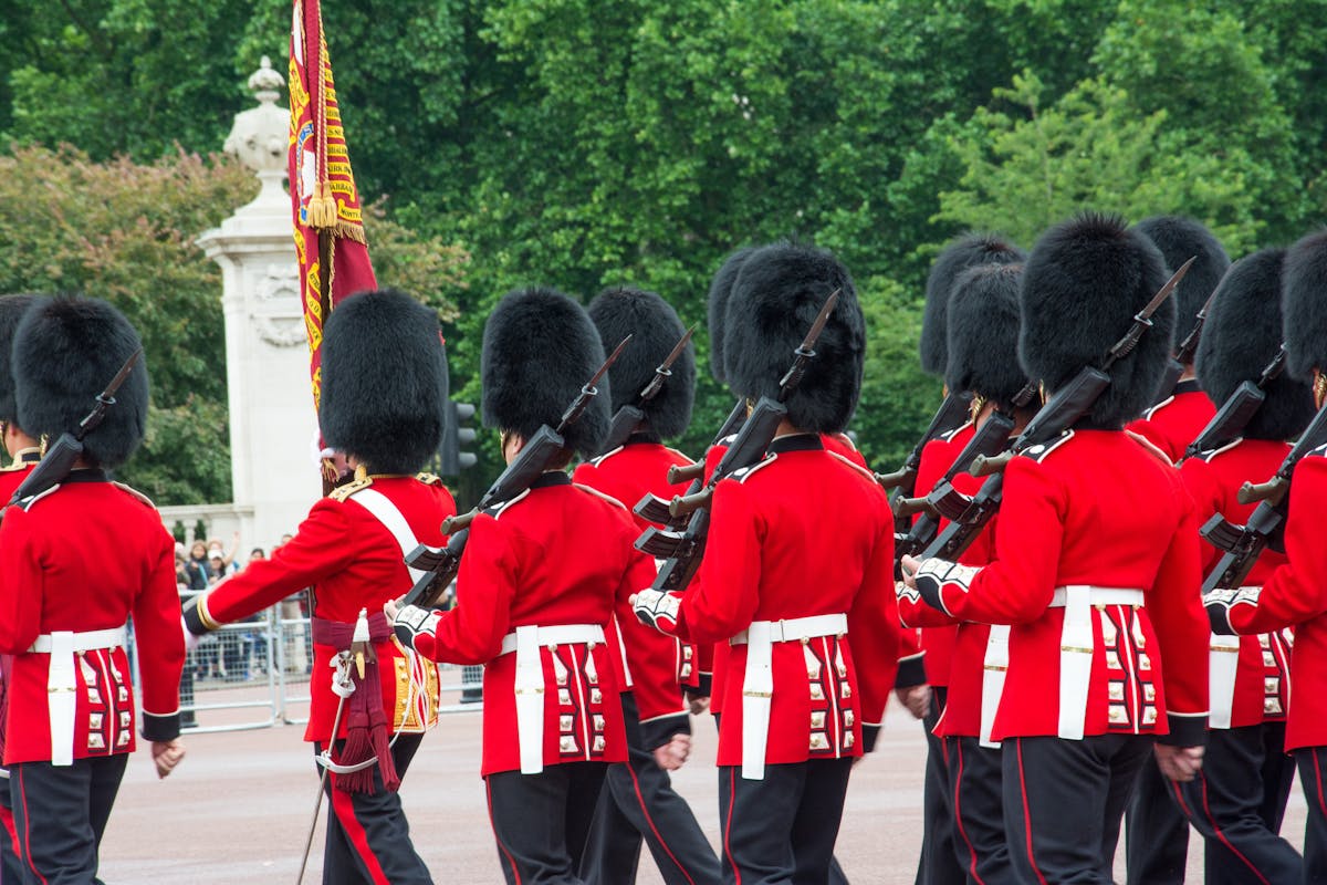 British Queens Guards march with rifles during ceremony
