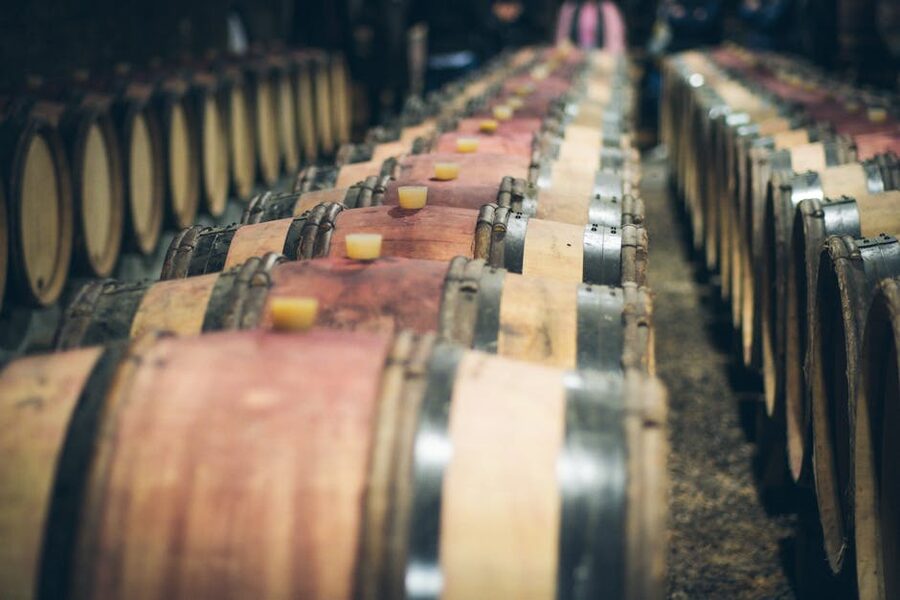 Wine barrels aging in a dimly lit cellar