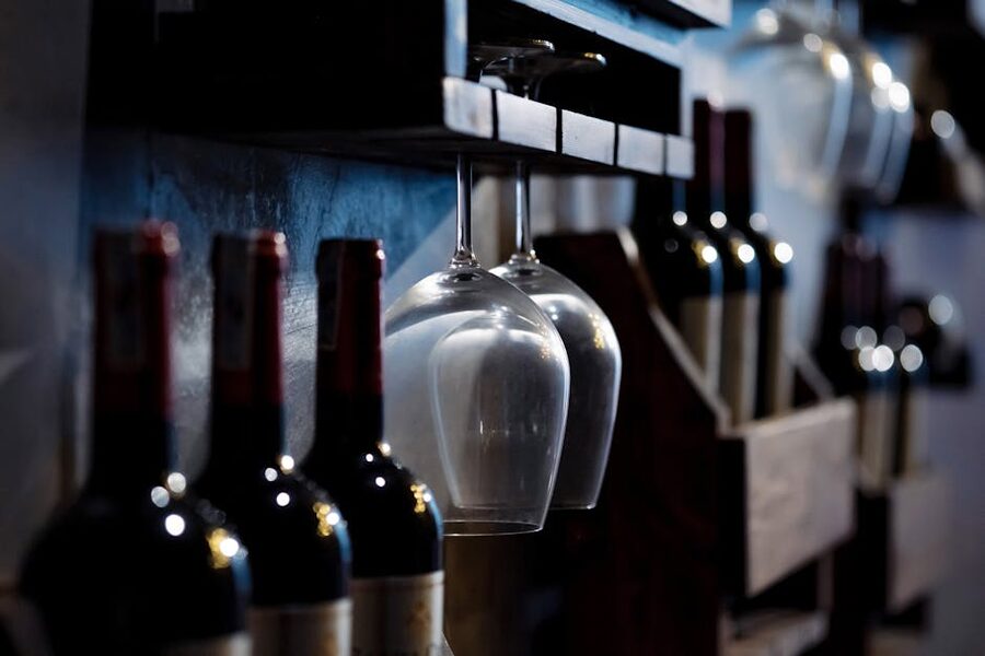Port wine bottles and glasses on cellar shelves