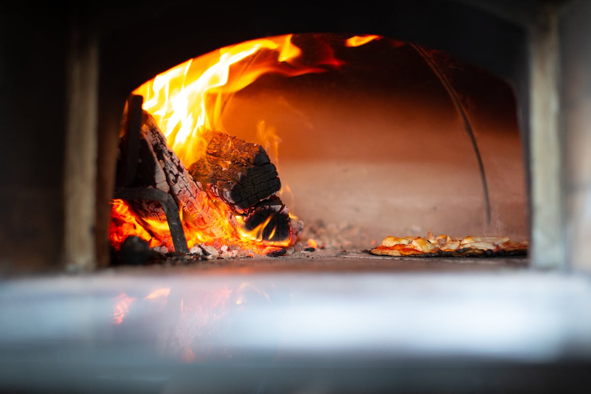 Traditional wood-fired oven with pizza baking inside