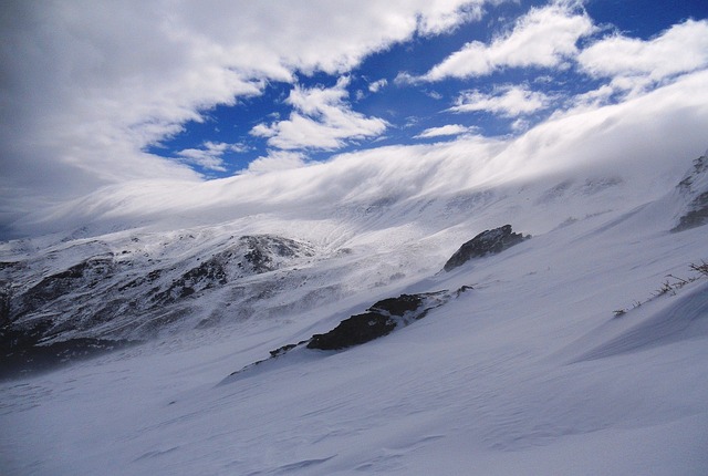 Snow-capped Sierra Nevada mountains against a blue sky in Andalusia