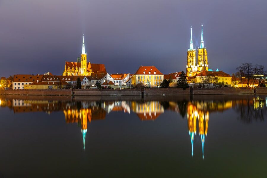Wroclaw Cathedral illuminated at night reflected in the Oder River