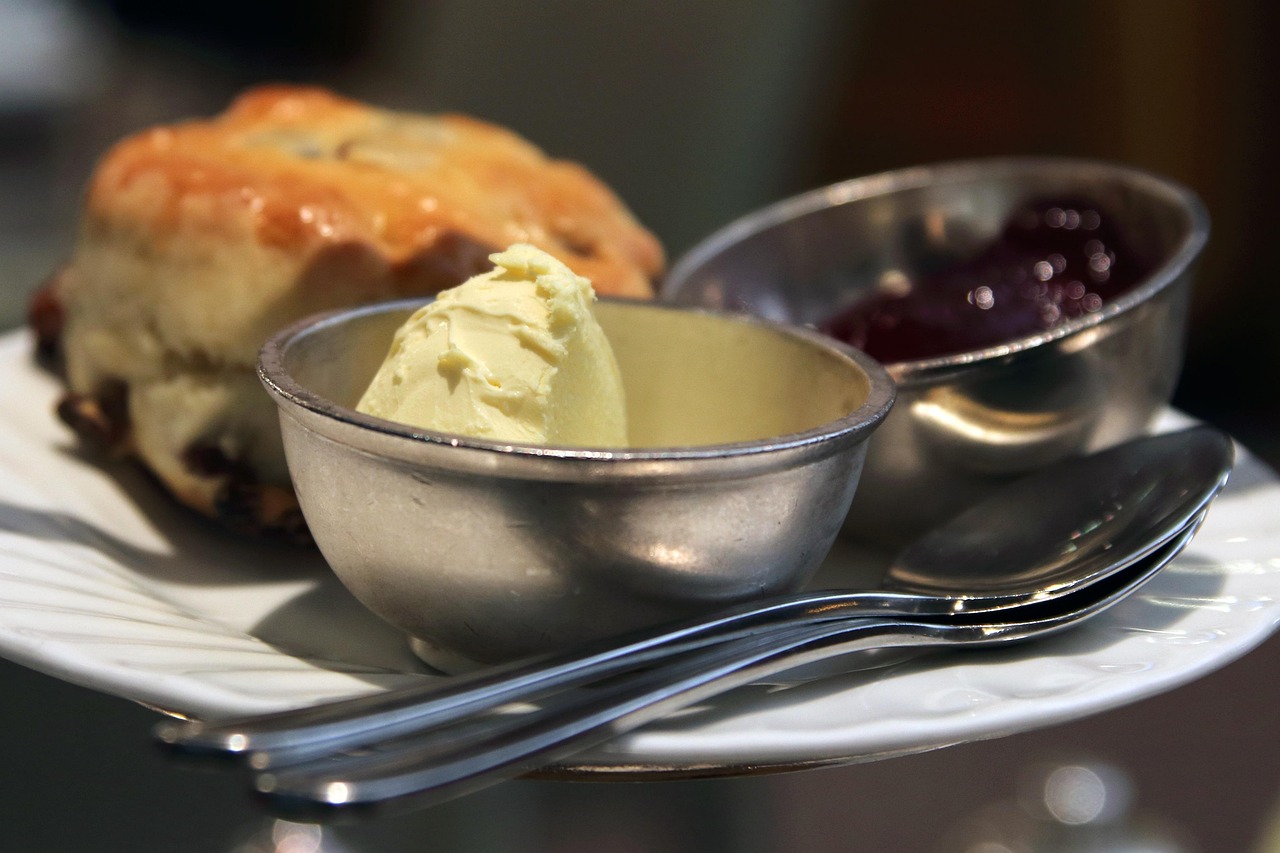 Traditional English cream tea with scones, clotted cream, and jam on a plate