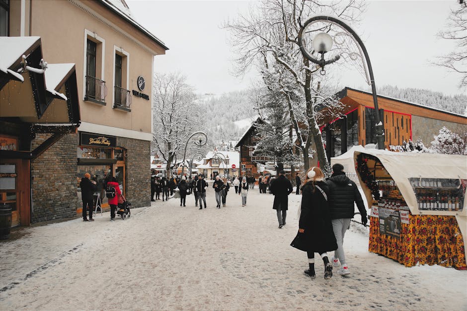 Snow-covered Krupowki Street in Zakopane, Poland with people walking