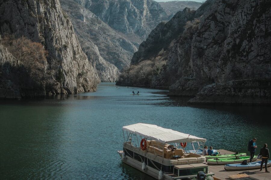 Canyon river with kayaks towering walls