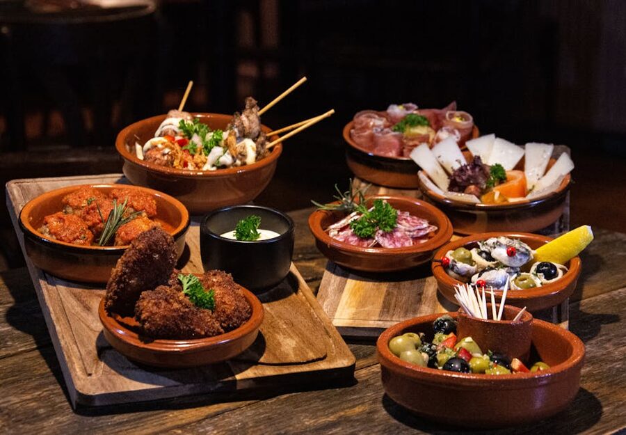 Assorted Spanish tapas dishes on rustic wooden table