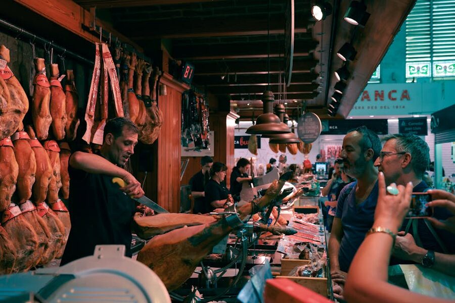 Barcelona market butcher slicing authentic Spanish jamon
