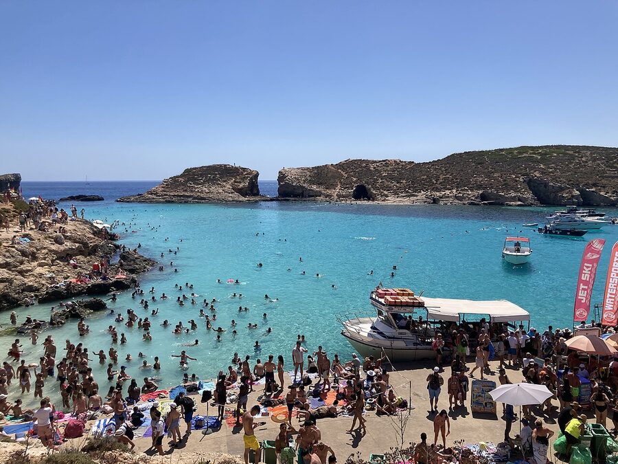The small sandy beach at the Blue Lagoon with rocks and clear water