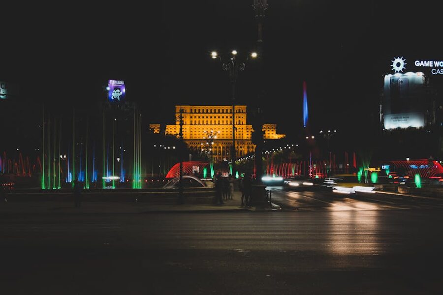 Bucharest Unirii fountains at night with Palace of Parliament axis