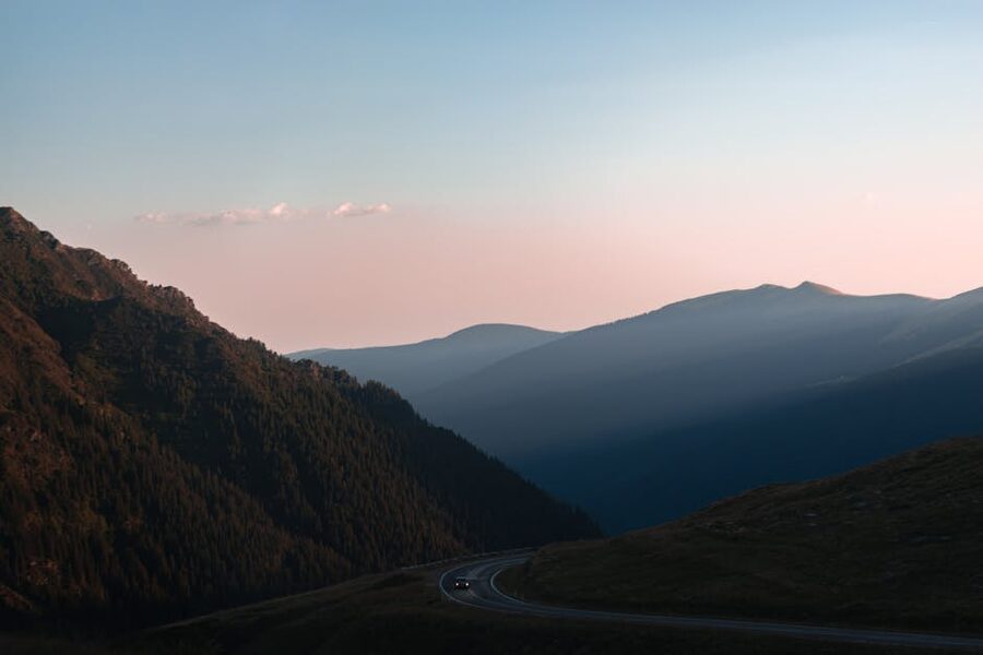 Winding mountain road through the Romanian Carpathians at sunset