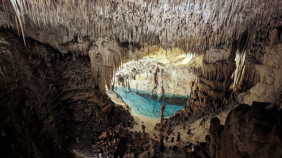Tiered stone seating facing Lake Martel inside Caves of Drach Mallorca
