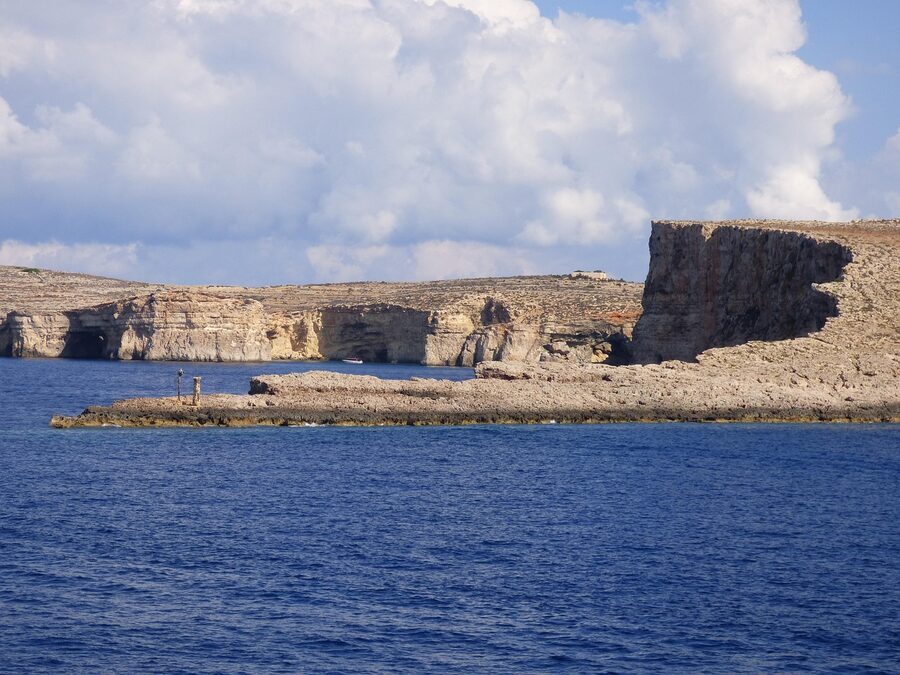 Comino island cliffs above clear Mediterranean water