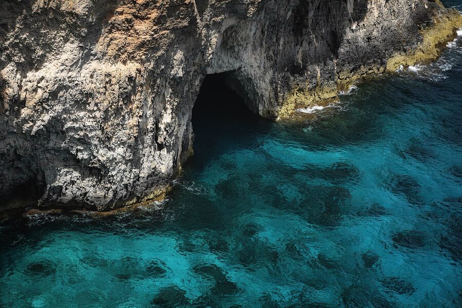 Sea caves on the coast of Comino with turquoise water