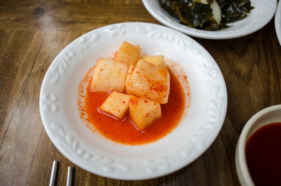 Spicy Korean radish kimchi in a white dish