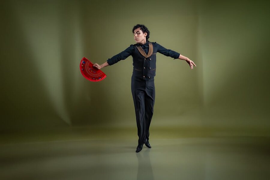 Flamenco dancer pose with red fan