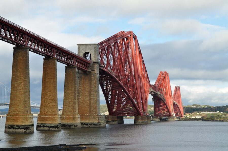 The Forth Bridge in red steel against a cloudy Scottish sky
