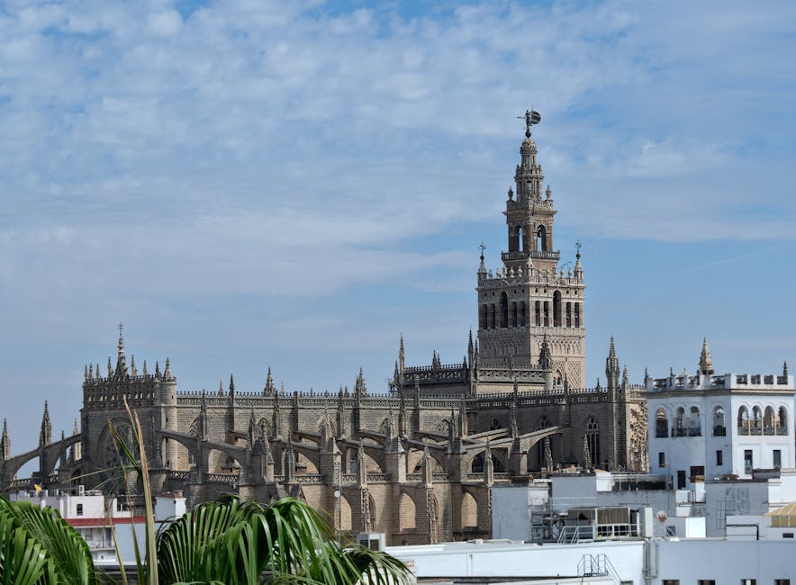 Giralda Tower of Seville Cathedral against blue sky