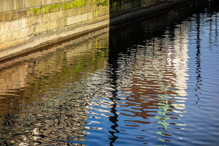 Rippled canal reflection of buildings from Fredsbron in Gothenburg