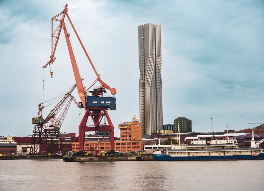 Gothenburg harbour with Karlatornet skyscraper and shipyard cranes by the river
