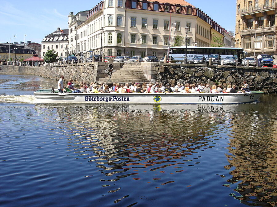 Paddan canal cruise boat passing under a low bridge in Gothenburg