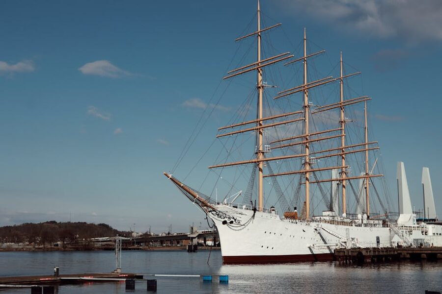 Tall ship moored in Gothenburg harbour with cranes in the background