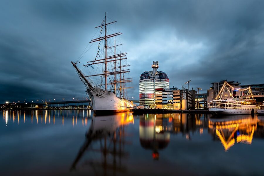 Gothenburg waterfront at twilight with sailing ships at Lilla Bommen