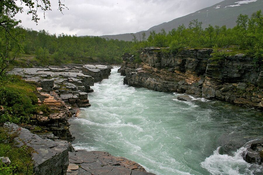 Walls of the Abiskojokk canyon dropping into the river bed