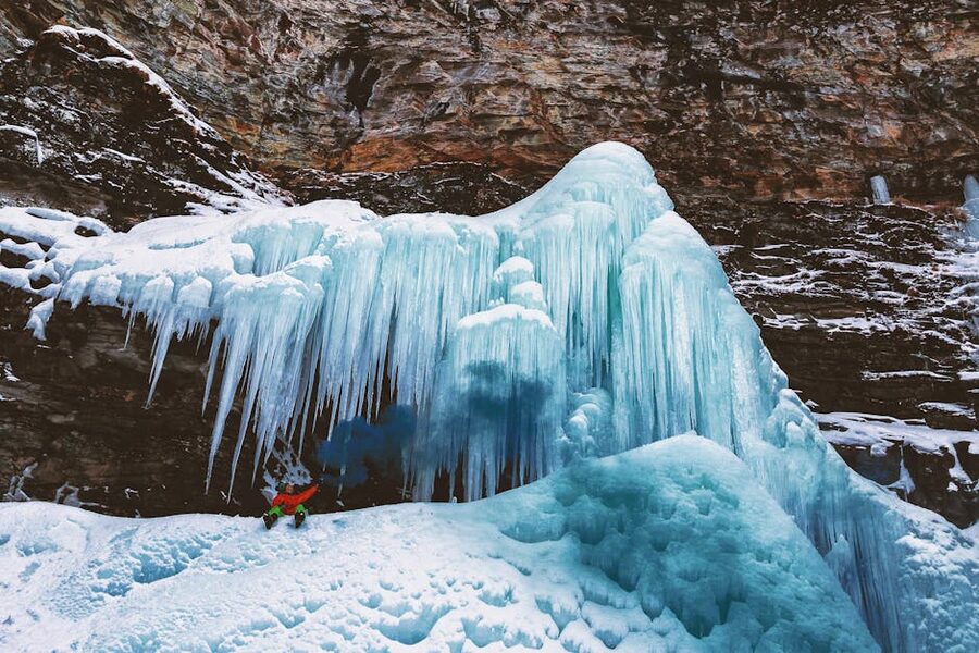 Hanging icicles on a frozen waterfall in winter mountains