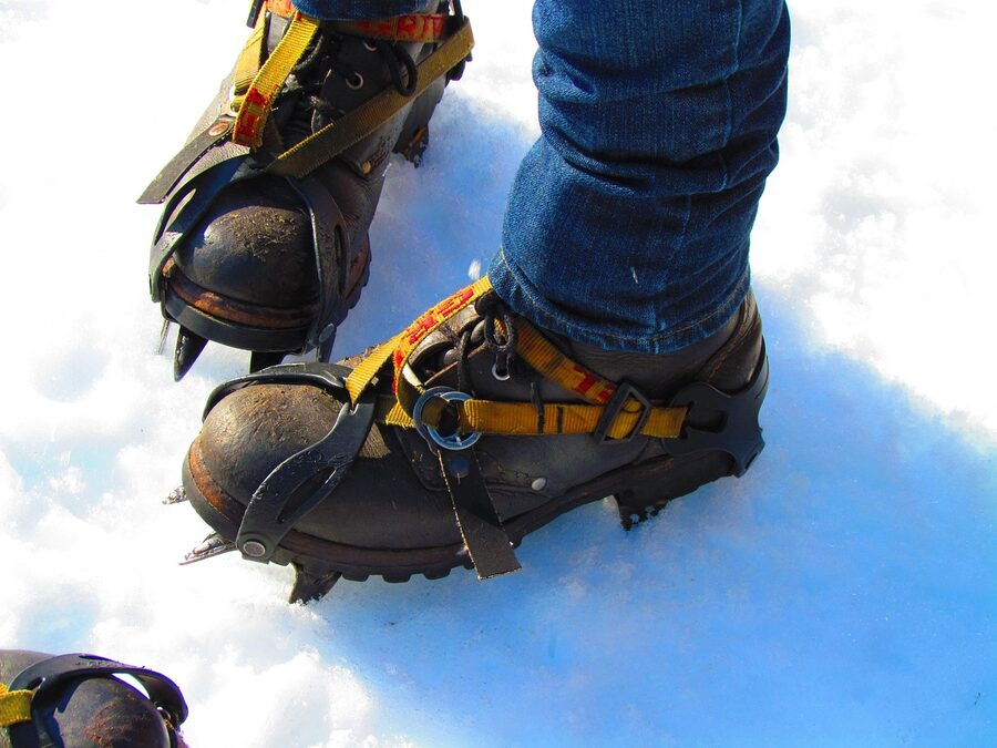 Mountaineering boots with crampons in snow