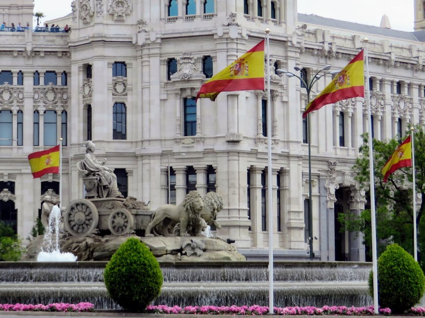 Cibeles Fountain Madrid with Spanish flags and Palacio de Cibeles